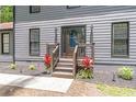 Elegant front entrance featuring a wooden door, gray siding and well-maintained landscaping at 155 N Fayette Dr, Fayetteville, GA 30214