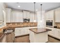 Bright kitchen featuring stainless steel appliances, granite counters, and a center island at 229 Traditions Drive Southeast Dr, Loganville, GA 30052