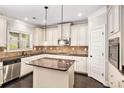 Well-lit kitchen with stainless steel appliances and a center island with granite countertops at 229 Traditions Drive Southeast Dr, Loganville, GA 30052