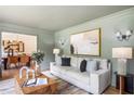 Bright living room with stylish decor, hardwood floors, and seamless connection to the adjacent dining area at 4049 Northlake Creek Cv, Tucker, GA 30084