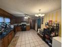Practical kitchen layout with tile floors and a view into the adjacent room at 4147 Scofield Pl, Stonecrest, GA 30083