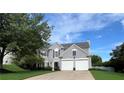 Traditional two-story home with a well-maintained lawn, blue shutters, and a two-car garage at 7325 Brookwood Way, Cumming, GA 30041