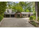 Beautiful home showcasing a manicured lawn, two-car garage, and brick-accented facade at 366 Blackland Nw Rd, Atlanta, GA 30342