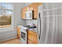 Modern kitchen with stainless steel appliances, wooden cabinetry, and a window with natural light at 1430 Dresden Ne Dr # 215, Atlanta, GA 30319