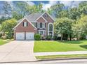 Two-story brick home with a manicured lawn, two car garage, and a large front window at 4157 Berkeley Nw Lndg, Kennesaw, GA 30144