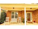 Inviting front porch with rocking chairs, a bench, and beautiful plants on the entrance at 4978 Arborview Pkwy, Acworth, GA 30101