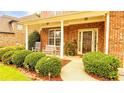 Inviting front porch with rocking chairs and lush landscaping creating a welcoming entrance at 4978 Arborview Pkwy, Acworth, GA 30101