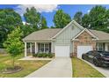 Charming single-story home with a well-maintained front yard, covered porch, and attached one car garage at 560 Vandenburg Dr, Villa Rica, GA 30180