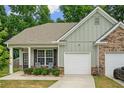 Charming single-story home with a well-maintained front yard, covered porch, and attached one car garage at 560 Vandenburg Dr, Villa Rica, GA 30180