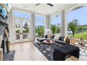 Bright and airy living room with a modern fireplace, stylish furniture, and large windows offering scenic views at 100 5Th St, Fayetteville, GA 30214