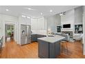 Modern kitchen featuring stainless steel appliances, an island, and hardwood floors at 1335 Joy Ct, Suwanee, GA 30024