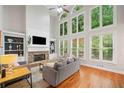 Bright living room with large windows, a fireplace, and hardwood floors at 1335 Joy Ct, Suwanee, GA 30024