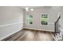 Bright, open dining room with hardwood floors, large windows, and classic trim, ready for your personal touch at 176 Windy Cir, Mcdonough, GA 30253