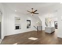 Open-concept living room with hardwood floors, fireplace, and seamless flow to the kitchen at 2335 Mason Dr # D27, Atlanta, GA 30316