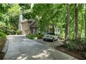 A beautiful home, nestled among mature trees, with a charming driveway at 1170 Spring Oak Way, Cumming, GA 30041