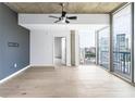 Spacious bedroom with hardwood floors, a ceiling fan, and large windows offering stunning city views at 3324 Peachtree Ne Rd # 2518, Atlanta, GA 30326