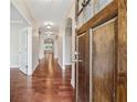 Inviting hallway with hardwood floors and arched doorways at 430 La Perla Dr, Sugar Hill, GA 30518
