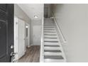 Bright entryway with hardwood floors and staircase, leading to upper levels at 5667 Cascade Sw Run, Atlanta, GA 30336