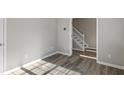 Neutral room with hardwood floors offers view of entryway and staircase at 5667 Cascade Sw Run, Atlanta, GA 30336