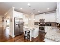 Modern kitchen featuring white cabinets, stainless steel appliances, and granite countertops, perfect for cooking at 637 Little Bear Loop, Canton, GA 30114