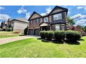 Attractive home with a brick facade, two-car garage, and lush green lawn at 958 Nevis Way, Mcdonough, GA 30253