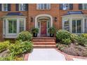 Covered front entrance featuring brick steps, arched entry, and sidelight windows at 1835 Redbourne Dr, Atlanta, GA 30350