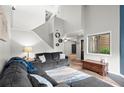 Bright, open-concept living room with soaring ceilings, stylish furnishings, and a view of the entry foyer at 301 Parkaire Xing, Marietta, GA 30068