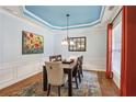 Formal dining room featuring beautiful blue tray ceiling and modern décor at 606 Lorimore Pass, Canton, GA 30115