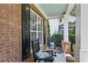 Inviting front porch with rocking chairs offers a relaxing outdoor space with brick accents at 606 Lorimore Pass, Canton, GA 30115