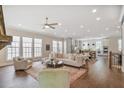 Open-concept living room featuring hardwood floors, recessed lighting, and many windows at 385 Rowes Cir, Alpharetta, GA 30009