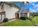 Well-maintained two-story home with lush green lawn and mature landscaping at 6177 Idlewood Cir, Lithonia, GA 30038