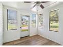 Bright sunroom with wood-look floors and multiple windows at 1186 Eastview Ne Rd, Conyers, GA 30012
