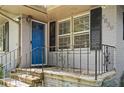 Inviting brick front porch with ornamental railings and a bright blue front door at 2839 Orion Dr, Decatur, GA 30033