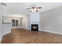 Inviting living area with hardwood floors, cozy fireplace, and ample natural light at 2894 Regent Walk Dr, Duluth, GA 30096
