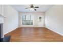 Open living space with hardwood floors, neutral walls, and large window with natural light at 2894 Regent Walk Dr, Duluth, GA 30096