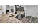 Modern kitchen featuring granite countertops, stainless steel appliances, and sleek dark cabinetry at 3262 Beech Hollow Ct, Loganville, GA 30052