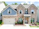 Charming brick and blue two-story home boasts a well-manicured lawn and inviting entryway at 4824 Sultana Sw Way, Atlanta, GA 30331