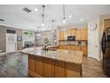 Spacious kitchen featuring an island, wood floors, and bright lighting at 1028 Constitution Way, Cumming, GA 30040