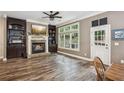 Cozy living room with a fireplace, built-in shelving, and large windows at 1028 Constitution Way, Cumming, GA 30040