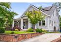Attractive home with green lawn, brick retaining wall, charming front porch, and updated solar panels at 1338 Iverson Ne St, Atlanta, GA 30307