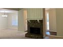 Spacious living room with a stone fireplace, neutral carpet, and views to other rooms at 4525 N Landing Dr, Marietta, GA 30066
