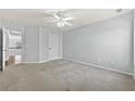 Spacious bedroom with neutral paint, ceiling fan, and plush carpet flooring at 120 Daniel Creek Ln, Sugar Hill, GA 30518