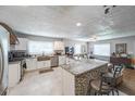 Bright kitchen with white cabinets, stainless steel appliances, granite counters, mosaic backsplash and breakfast bar at 1279 Skyhaven Se Rd, Atlanta, GA 30316