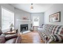 Cozy living room featuring a classic fireplace, hardwood flooring, and bright windows at 1279 Skyhaven Se Rd, Atlanta, GA 30316