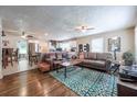 Spacious open-concept living room and kitchen, complete with hardwood floors, granite counters and modern ceiling fan at 1279 Skyhaven Se Rd, Atlanta, GA 30316