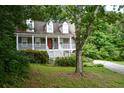 Charming two-story home with a welcoming front porch and landscaped front yard at 55 Legend Creek Cv, Douglasville, GA 30134