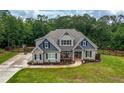 Inviting two-story home with stone accents, manicured landscaping, and a welcoming front porch at 7532 Milford Pl, Douglasville, GA 30135
