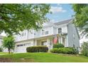 Inviting two-story home featuring a welcoming front porch and attached two-car garage at 233 Hampton Station Blvd, Canton, GA 30115