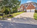 Exterior features a long concrete driveway that leads to the two-car garage at 358 Woodbrook Crst, Canton, GA 30114