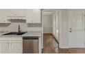 A modern kitchen with stainless steel appliances, dark countertops, a stainless sink and wood look floors at 3614 Spring Leaf Ln, Acworth, GA 30101